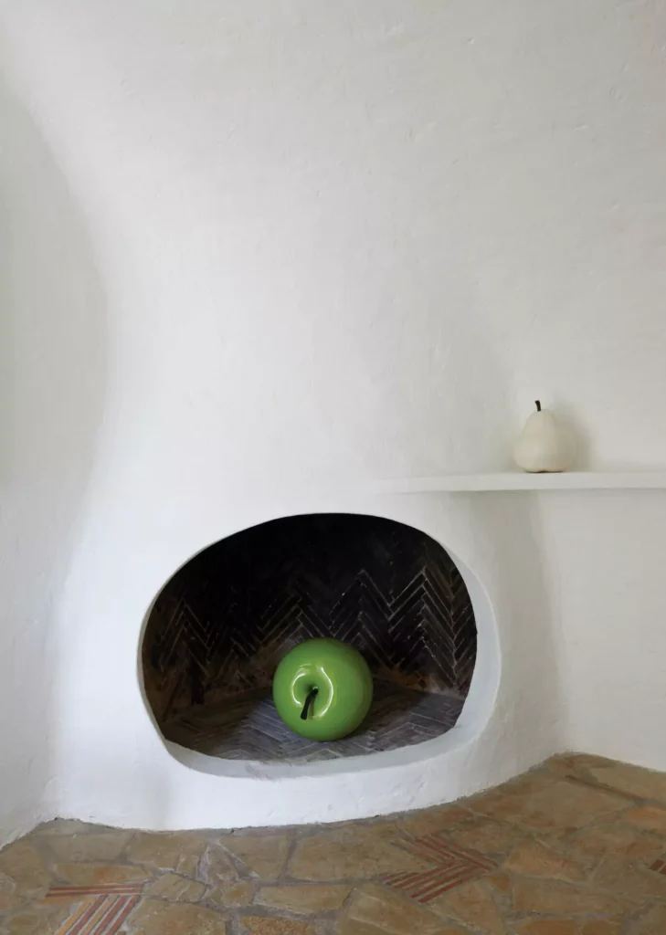 Fruit sculptures decorate a fireplace in the guesthouse.