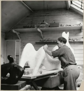 Henry Moore in his studio at Hoglands, Perry Green in Hertfordshire, working on ‘Reclining Figure’ for the 1951 Festival of Britain. © Historic England Archive. OP32771